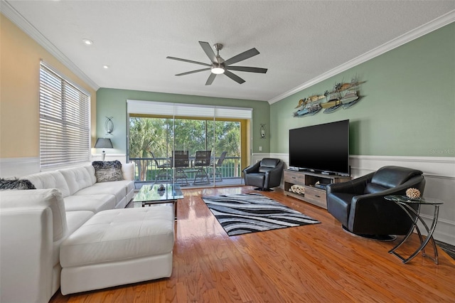 living room with crown molding, wood-type flooring, ceiling fan, and a textured ceiling