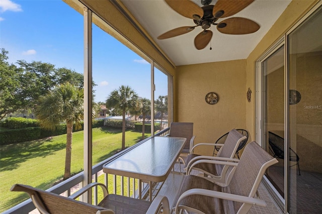 sunroom / solarium featuring ceiling fan