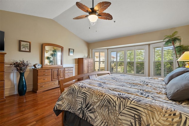 bedroom with wood-type flooring, ceiling fan, vaulted ceiling, and multiple windows