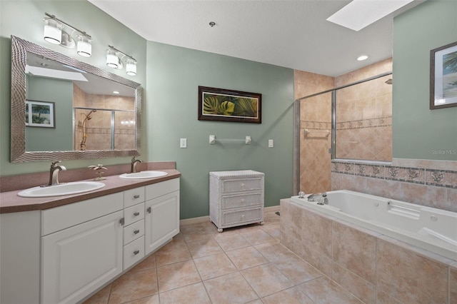 bathroom with a skylight, independent shower and bath, dual bowl vanity, and tile floors