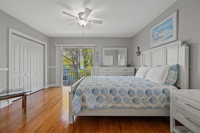 bedroom with wood-type flooring, ceiling fan, access to outside, and a closet