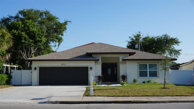 view of front of home with a garage and a front lawn