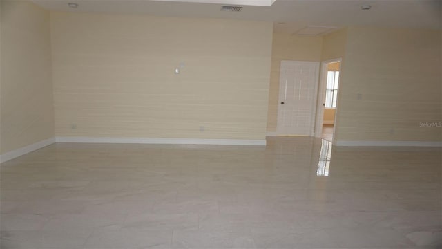 unfurnished room with tile floors