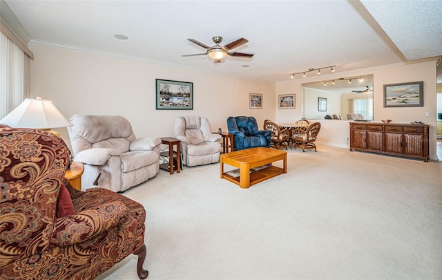 carpeted living room featuring crown molding, ceiling fan, a textured ceiling, and a wealth of natural light