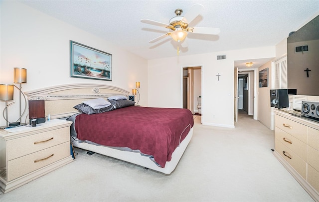 carpeted bedroom featuring a textured ceiling and ceiling fan