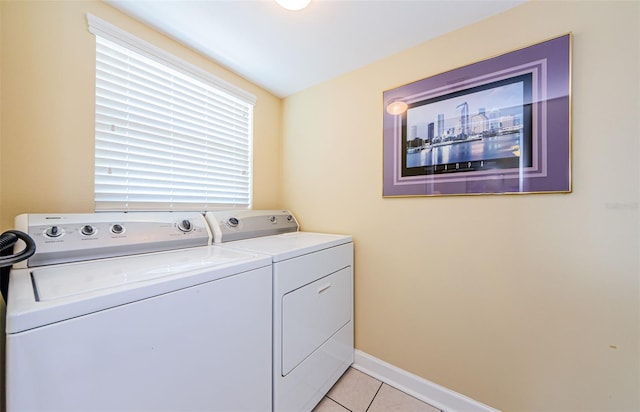 washroom with washer and clothes dryer and light tile patterned flooring