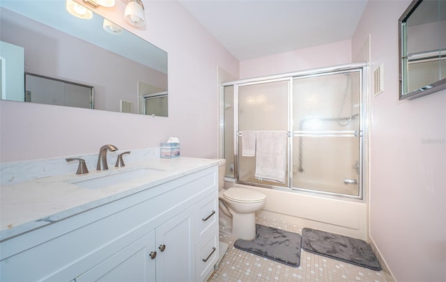 full bathroom with vanity, tile patterned flooring, enclosed tub / shower combo, and toilet