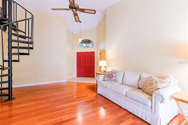 living room featuring hardwood / wood-style flooring, high vaulted ceiling, and ceiling fan