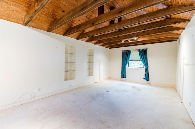 empty room with lofted ceiling with beams, wooden ceiling, and light colored carpet