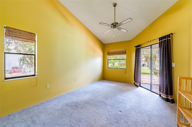 unfurnished room with light carpet, high vaulted ceiling, a textured ceiling, and ceiling fan