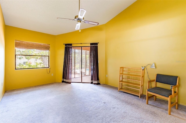 sitting room featuring ceiling fan, carpet, and vaulted ceiling