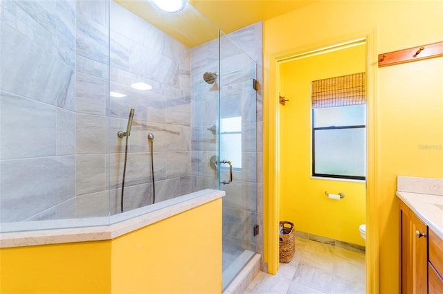 bathroom with vanity, tile patterned flooring, toilet, and an enclosed shower