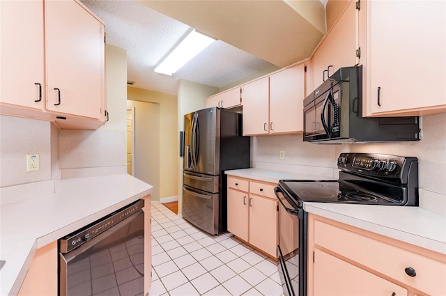 kitchen featuring a textured ceiling, black appliances, and light tile patterned flooring