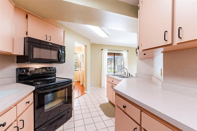 kitchen featuring light tile patterned floors, a textured ceiling, black appliances, and sink