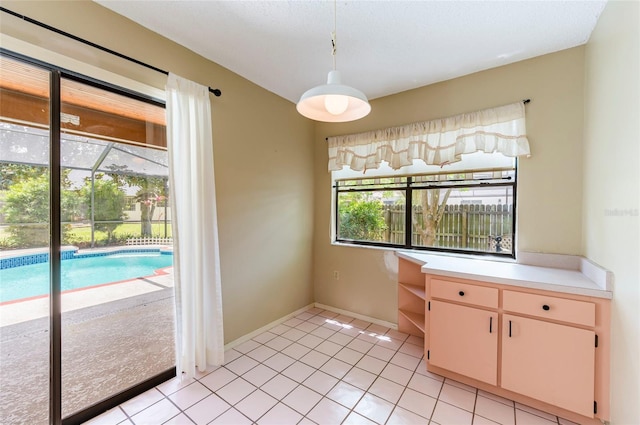 unfurnished dining area featuring light tile patterned floors