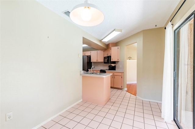 kitchen featuring black appliances, sink, a textured ceiling, kitchen peninsula, and light tile patterned floors