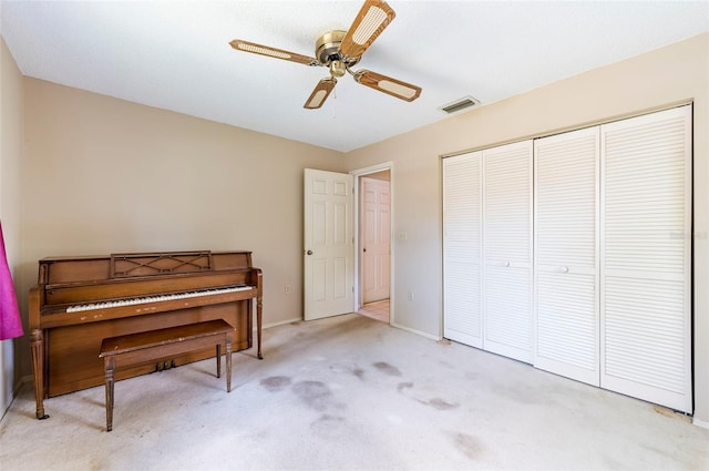 miscellaneous room with light colored carpet and ceiling fan