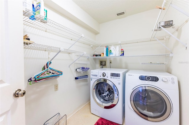 laundry area featuring washing machine and clothes dryer