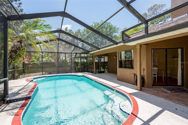 view of pool featuring a patio area and glass enclosure