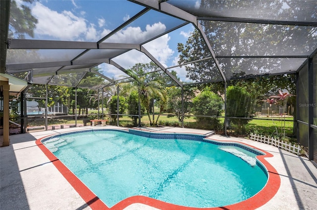 view of swimming pool featuring a patio and a lanai