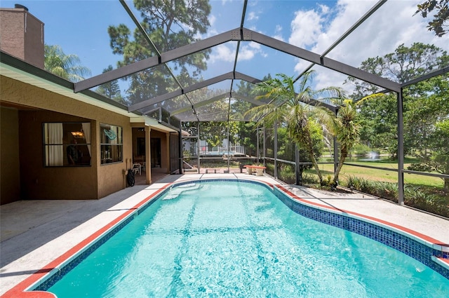 view of swimming pool with a patio and a lanai