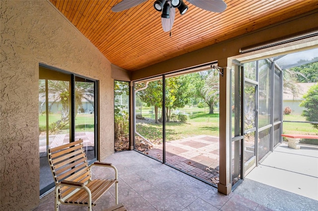 unfurnished sunroom with lofted ceiling, wood ceiling, and ceiling fan