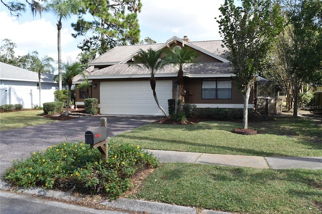 view of front of property featuring a front lawn and a garage