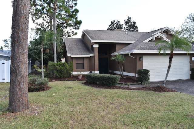 view of front of property featuring a front yard and a garage