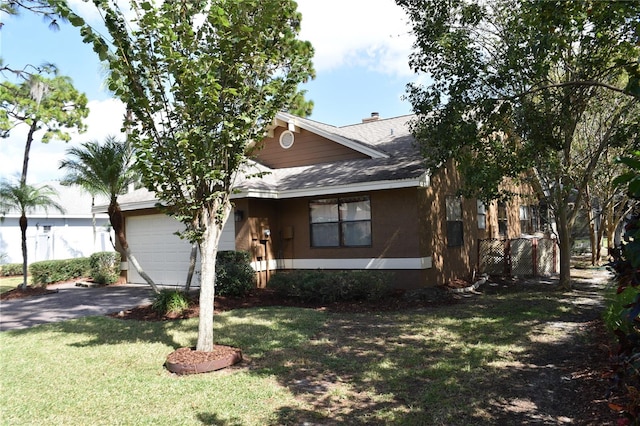 view of front of home with a front yard and a garage