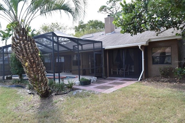 back of property with a patio area, a lanai, and a lawn