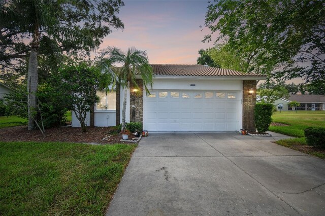 view of front of house featuring a yard and a garage