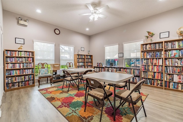 recreation room with ceiling fan and light wood-type flooring