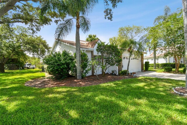 view of front facade featuring a garage and a front lawn