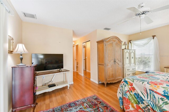 bedroom featuring ceiling fan and light hardwood / wood-style flooring