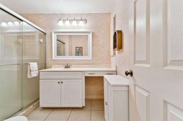 bathroom featuring vanity, tile patterned floors, and a shower with door