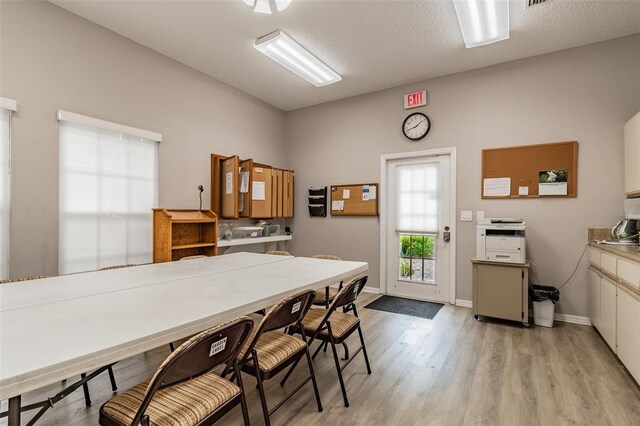 kitchen with light wood-type flooring and a textured ceiling