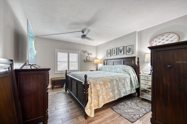 bedroom featuring wood-type flooring, ceiling fan, and a textured ceiling