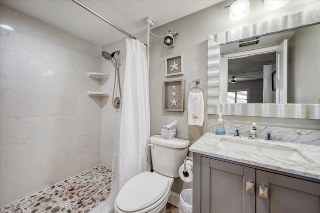 bathroom with vanity with extensive cabinet space, toilet, and walk in shower