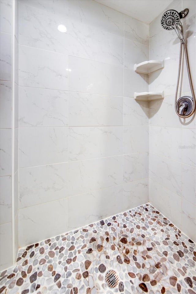 bathroom with tiled shower