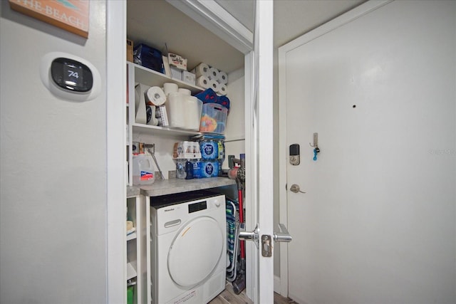 laundry room featuring wood-type flooring and washer / clothes dryer