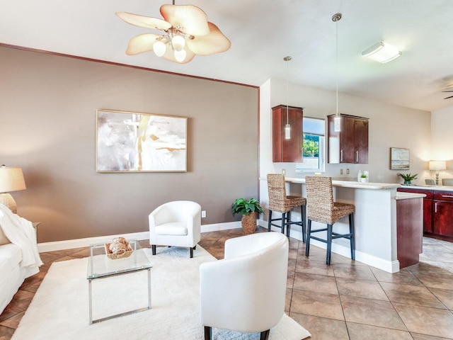 living room with ceiling fan and light tile patterned flooring