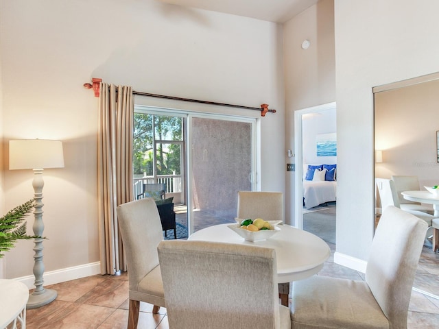 tiled dining room with a towering ceiling