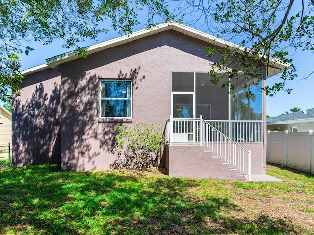 rear view of house featuring a lawn