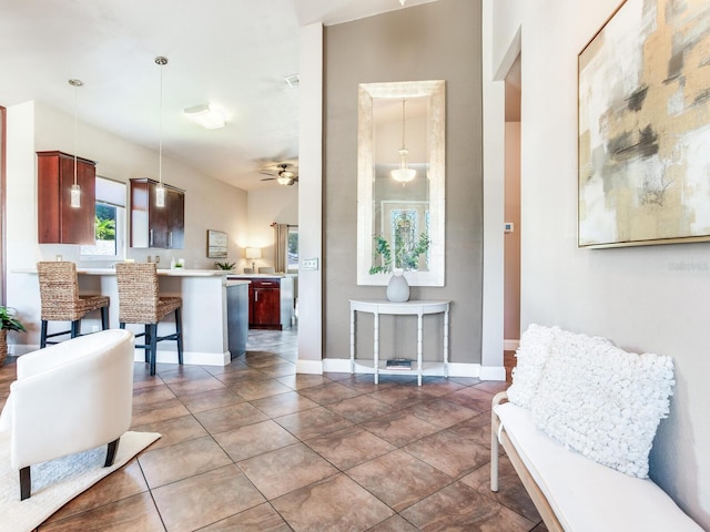 living room featuring ceiling fan and dark tile patterned floors