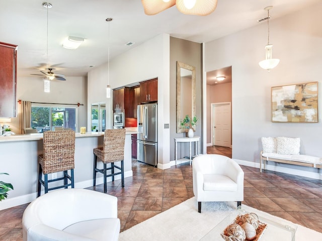 interior space with a high ceiling and ceiling fan