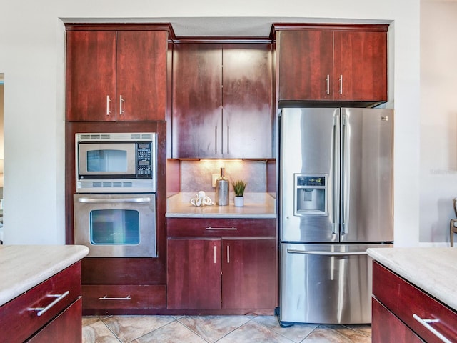 kitchen featuring light tile patterned flooring and stainless steel appliances