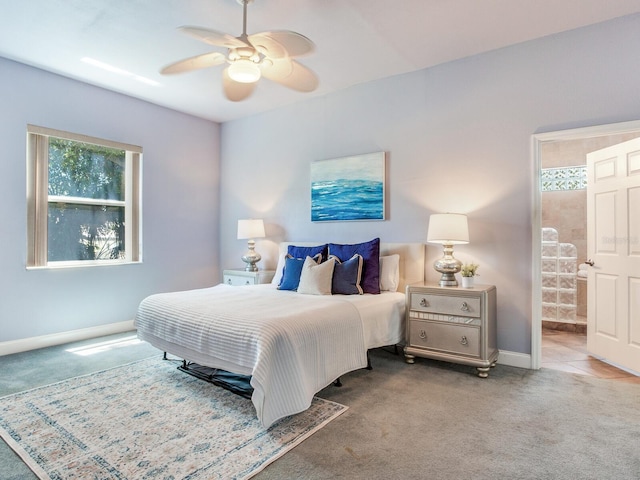 bedroom with ceiling fan, light carpet, and ensuite bath