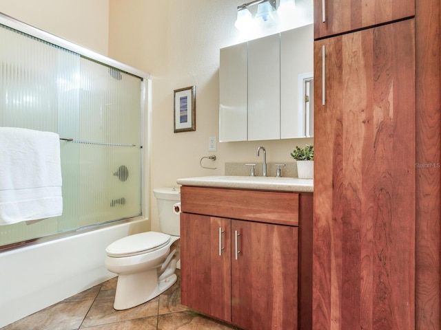 full bathroom featuring tile patterned floors, vanity, toilet, and enclosed tub / shower combo