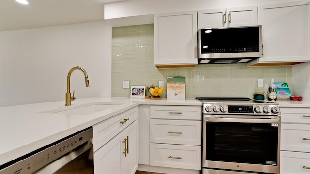 kitchen with tasteful backsplash, stainless steel appliances, sink, and white cabinetry