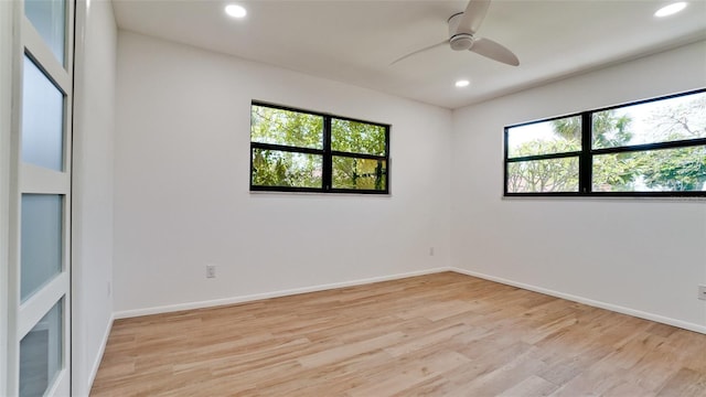 unfurnished room with ceiling fan and light hardwood / wood-style floors